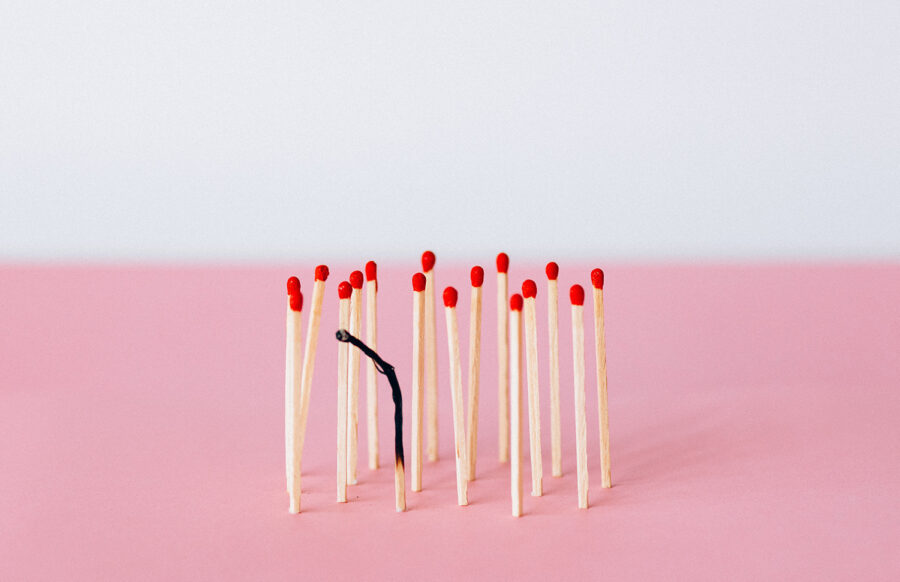 unlit matches surrounding a burned out match