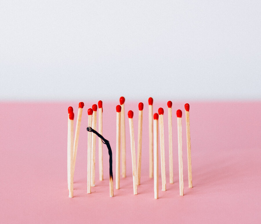 unlit matches surrounding a burned out match